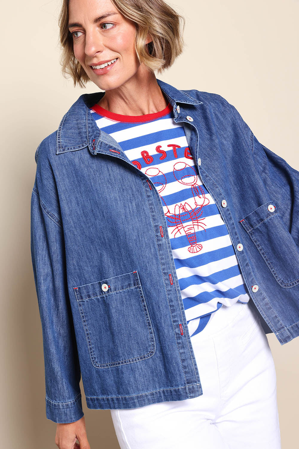 Model Riinar wearing size 10 of the Coast Crop Denim Jacket – Denim in colour Denim, from an angle