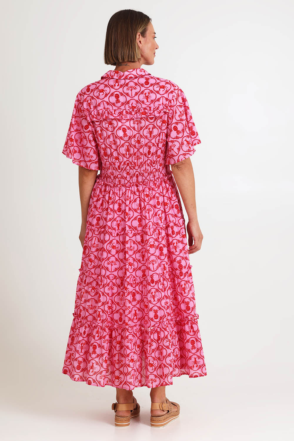 Model Riinar wearing size 10 of the Laguna Beach Print Dress – Rose in colour Rose, from the front