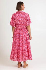 Model Riinar wearing size 10 of the Laguna Beach Print Dress – Rose in colour Rose, from the front