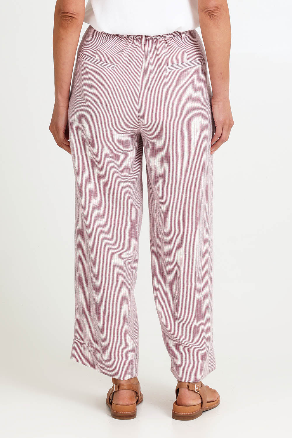 Model Riinar wearing size 10 of the City Stripe Pant - Redwhite in colour Redwhite, from the back