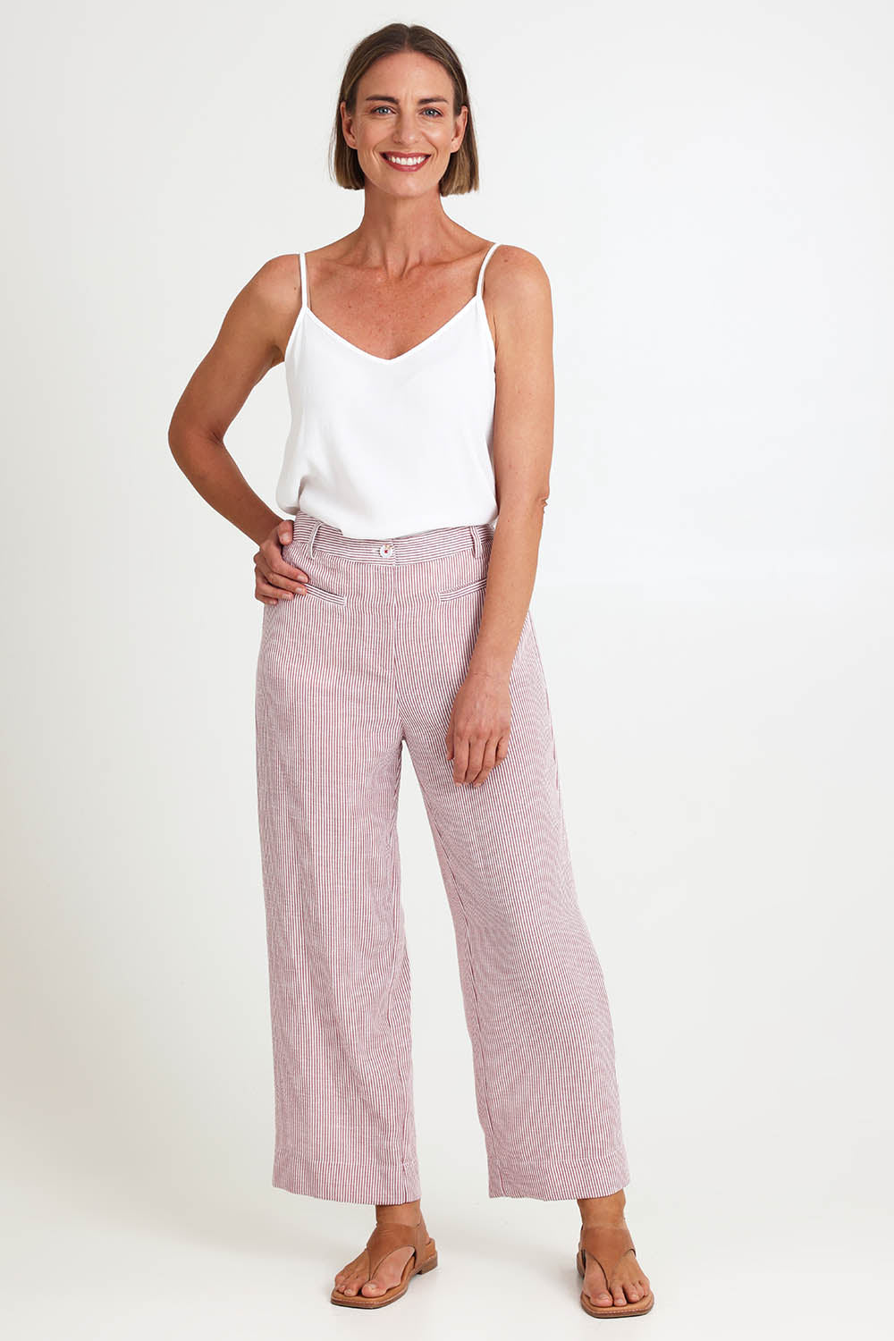 Model Riinar wearing size 10 of the City Stripe Pant - Redwhite in colour Redwhite, from the front