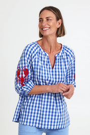 Model Riinar wearing size 10 of the Cove Check Top – Azure in colour Azure, from an angle
