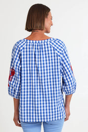Model Riinar wearing size 10 of the Cove Check Top – Azure in colour Azure, from the back