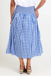Model Riinar wearing size 10 of the Amalfi Check Skirt – Azure in colour Azure, from the back
