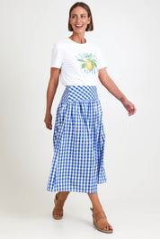 Model Riinar wearing size 10 of the Amalfi Check Skirt – Azure in colour Azure, from the front