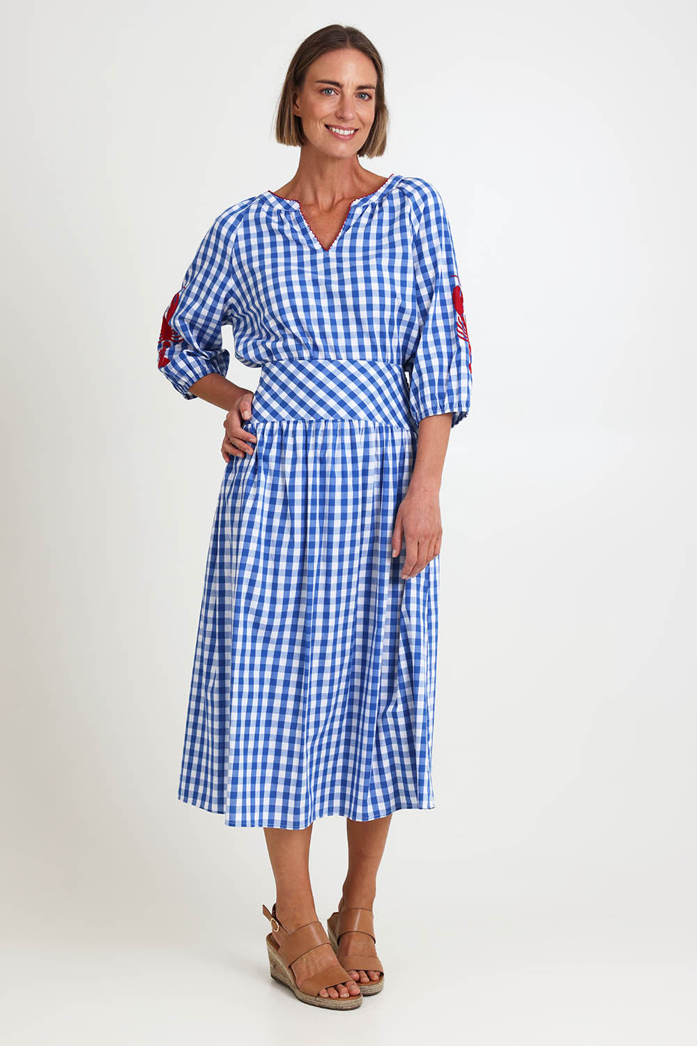 Model Riinar wearing size 10 of the Amalfi Check Skirt – Azure in colour Azure, from the front