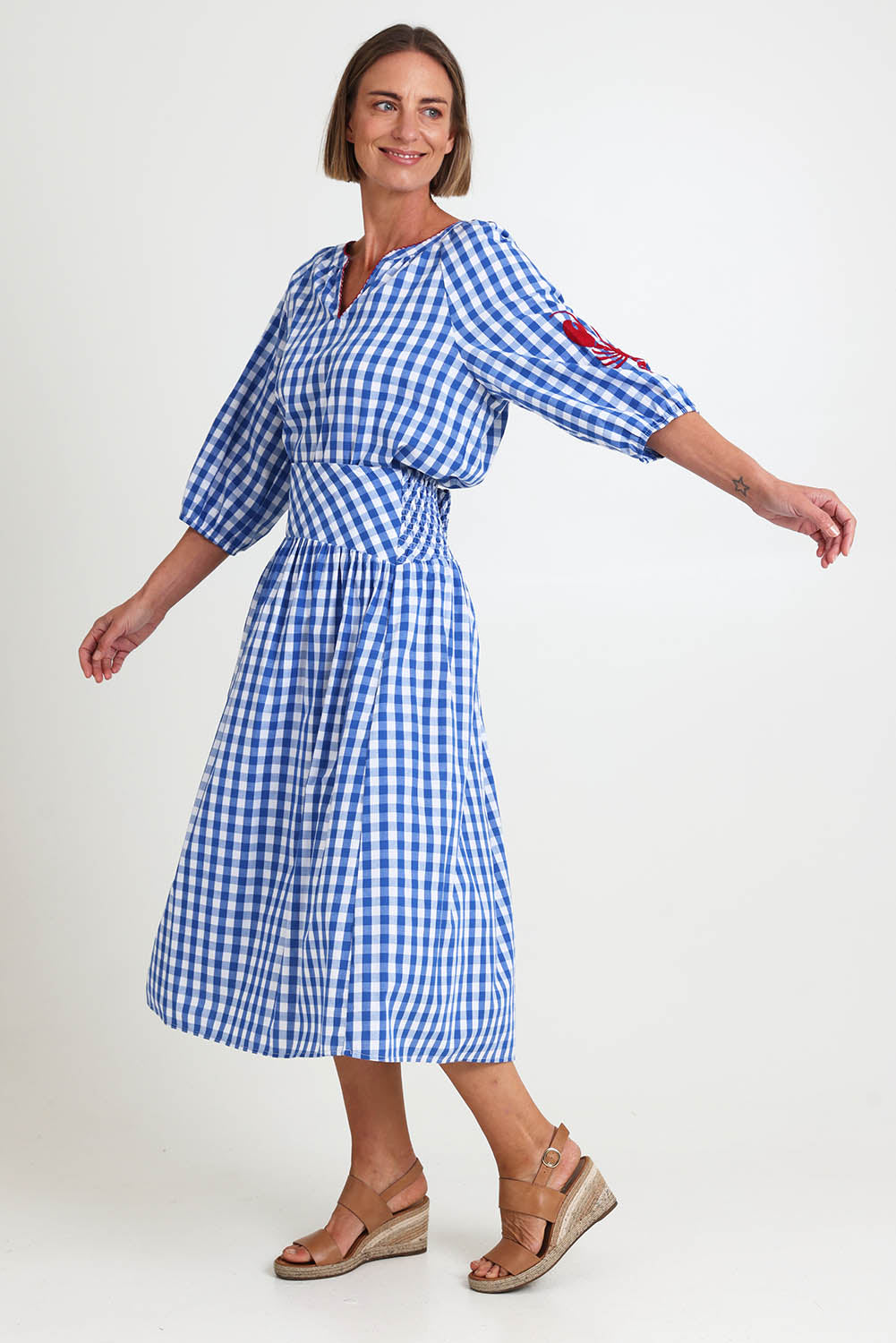 Model Riinar wearing size 10 of the Amalfi Check Skirt – Azure in colour Azure, from the front