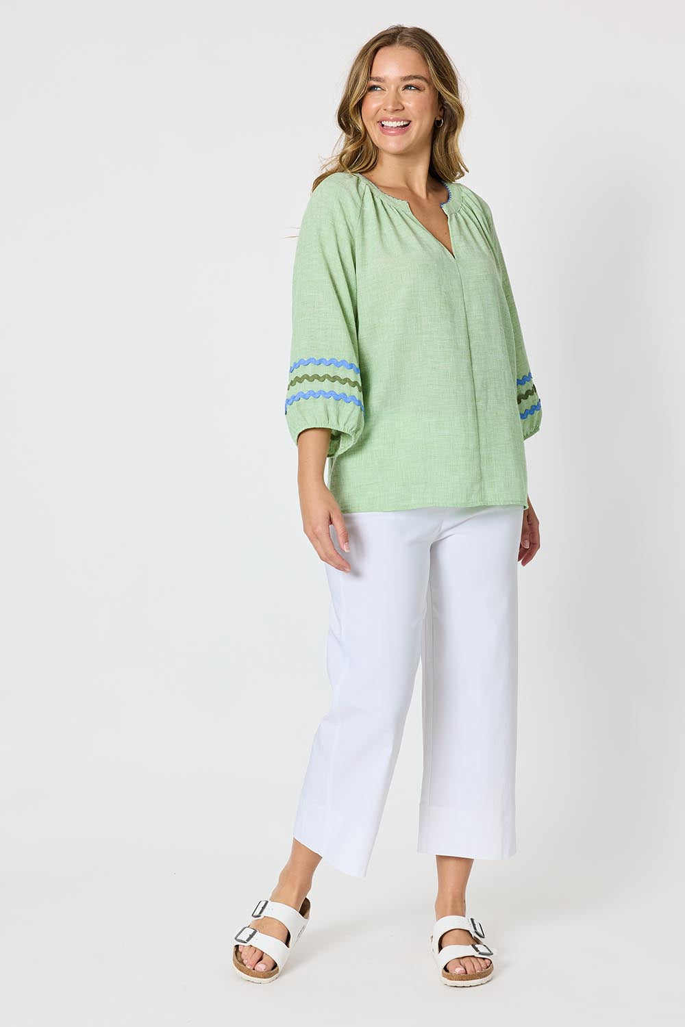 Model Genericm wearing size sample of the Canopy Ric Rac Top - Apple in colour Apple, from the front