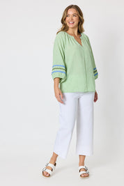 Model Genericm wearing size sample of the Canopy Ric Rac Top - Apple in colour Apple, from the front
