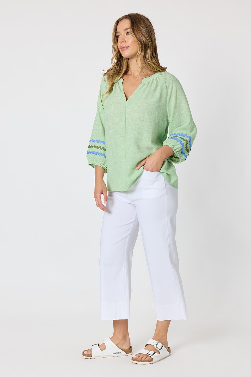 Model Genericm wearing size sample of the Canopy Ric Rac Top - Apple in colour Apple, from the front
