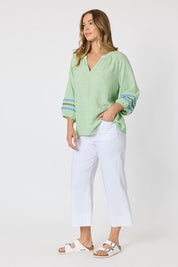 Model Genericm wearing size sample of the Canopy Ric Rac Top - Apple in colour Apple, from the front