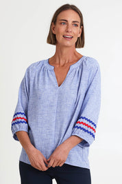 Model Riinar wearing size 10 of the Canopy Ric Rac Top – Chambray in colour Chambray, in a cropped view