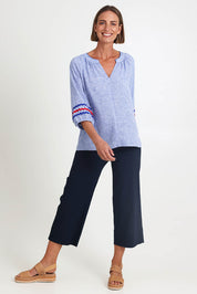 Model Riinar wearing size 10 of the Canopy Ric Rac Top – Chambray in colour Chambray, from the front