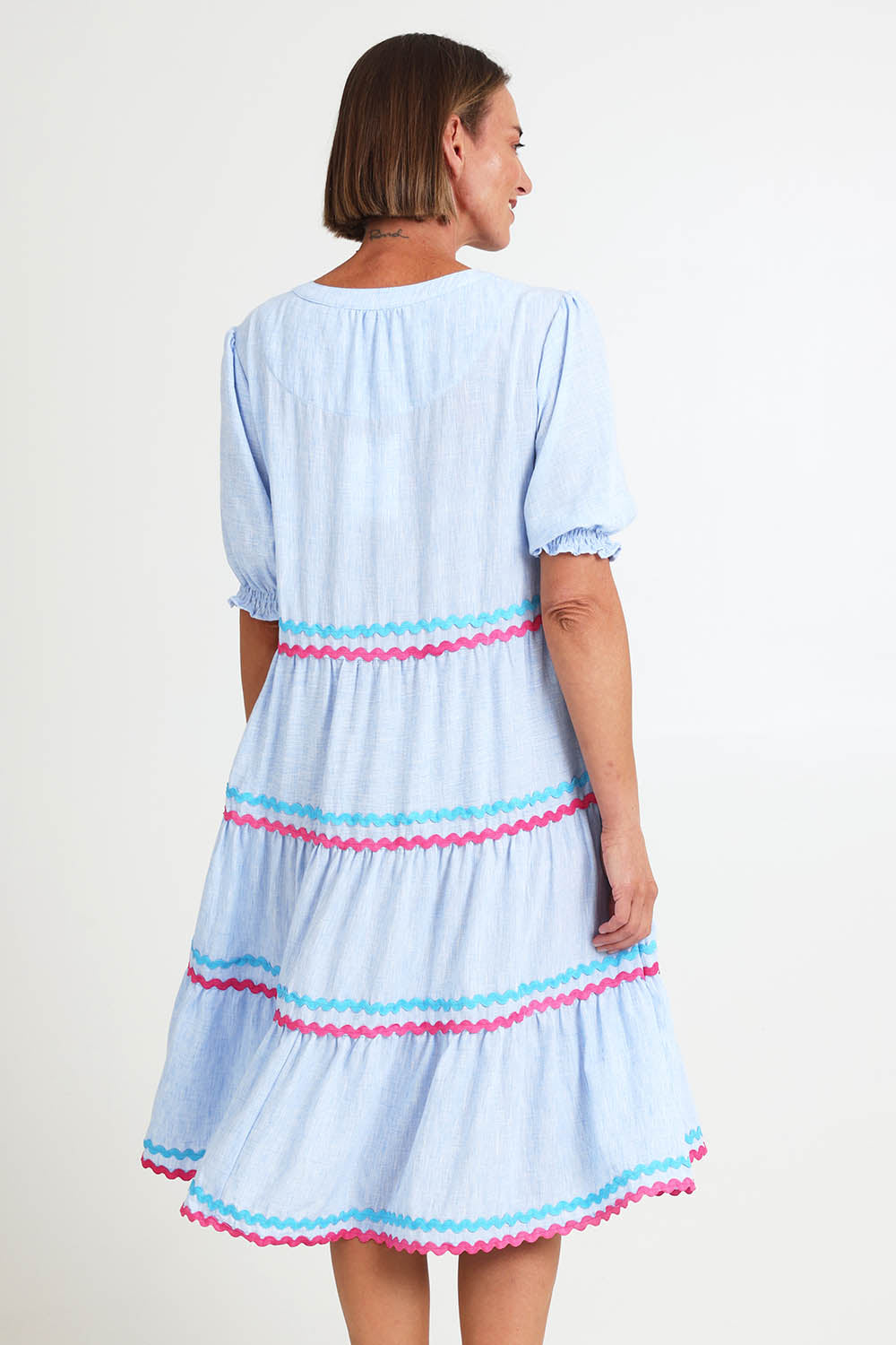 Model Riinar wearing size 10 of the Canopy Ric Rac Dress – Paleblue in colour Paleblue, from the back
