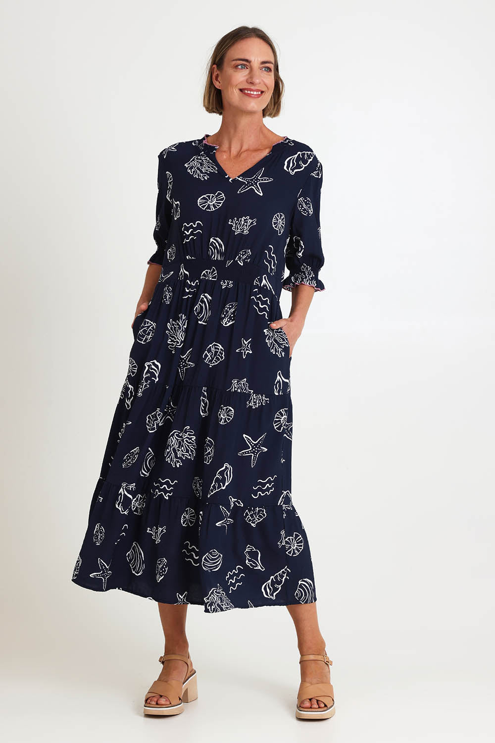 Model Riinar wearing size 10 of the Montecito Print Dress – Navy in colour Navy, from the front