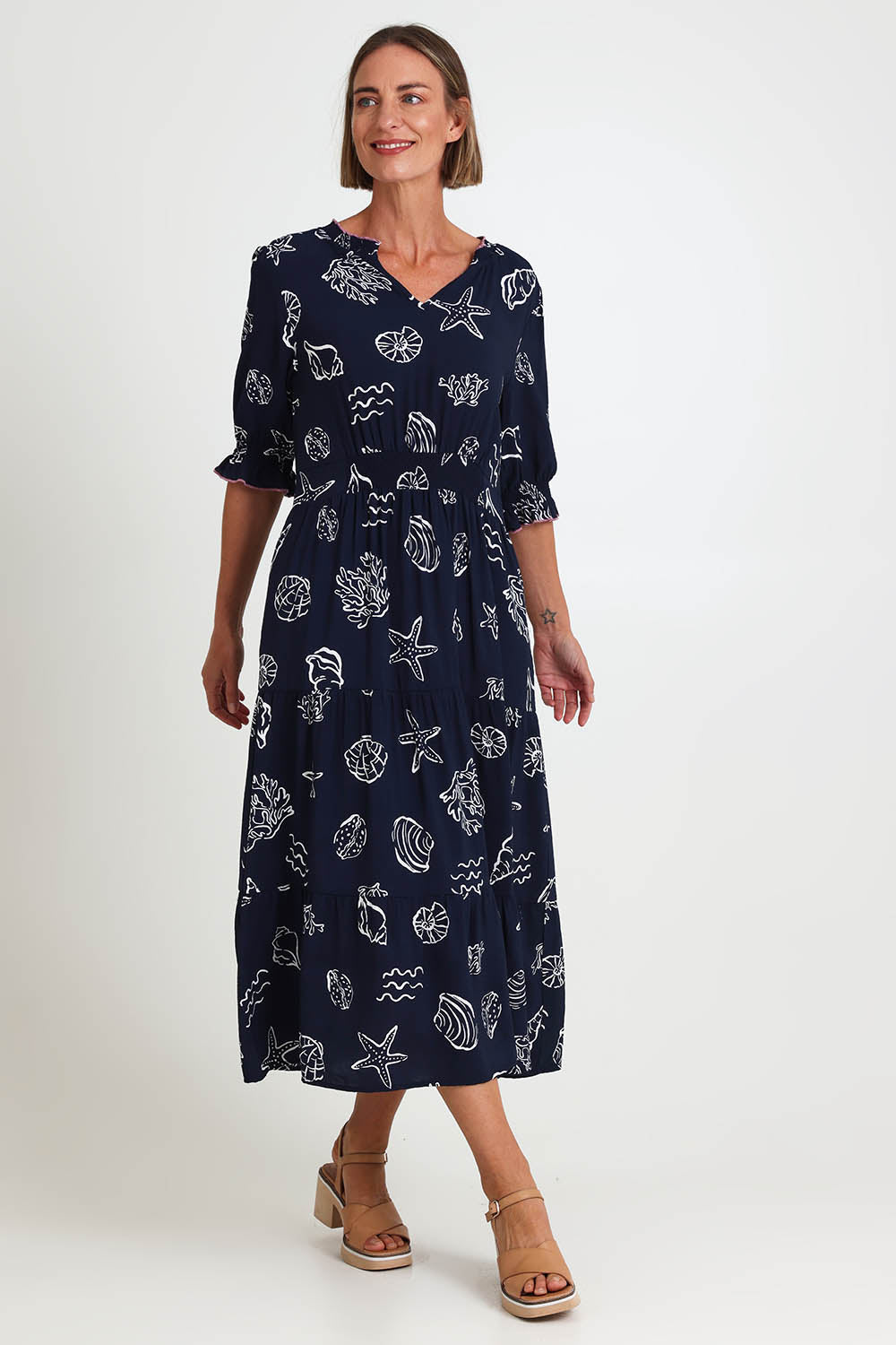 Model Riinar wearing size 10 of the Montecito Print Dress – Navy in colour Navy, from the front