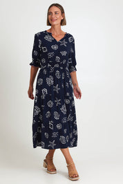Model Riinar wearing size 10 of the Montecito Print Dress – Navy in colour Navy, from the front