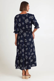 Model Riinar wearing size 10 of the Montecito Print Dress – Navy in colour Navy, from the front