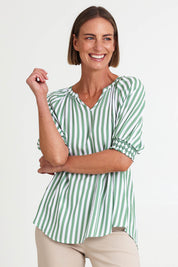 Model Riinar wearing size 10 of the Kalahari Stripe Top – Apple in colour Apple, from an angle