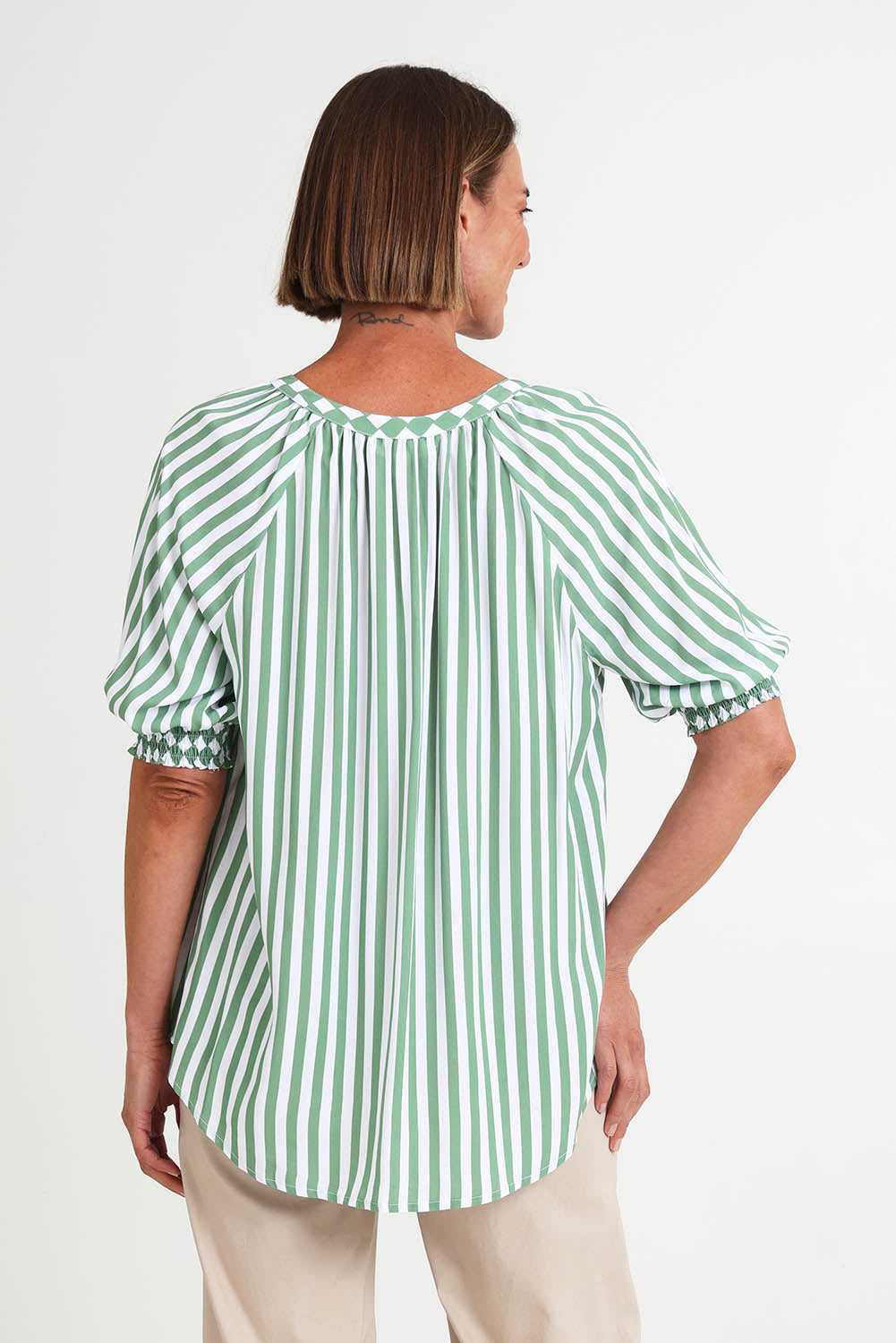 Model Riinar wearing size 10 of the Kalahari Stripe Top – Apple in colour Apple, from the back