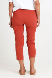 Model Riinar wearing size 10 of the Zara Pant - Ginger in colour Ginger, from the back
