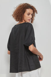 A model wearing the Bishop Sleeve Tee in colour Black (Black), from the back