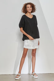 A model wearing the Bishop Sleeve Tee in colour Black (Black), from the front, showing the whole outfit