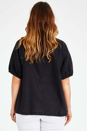 Model Laura wearing size L of the Bishop Sleeve Tee in colour Black (Black), from the back