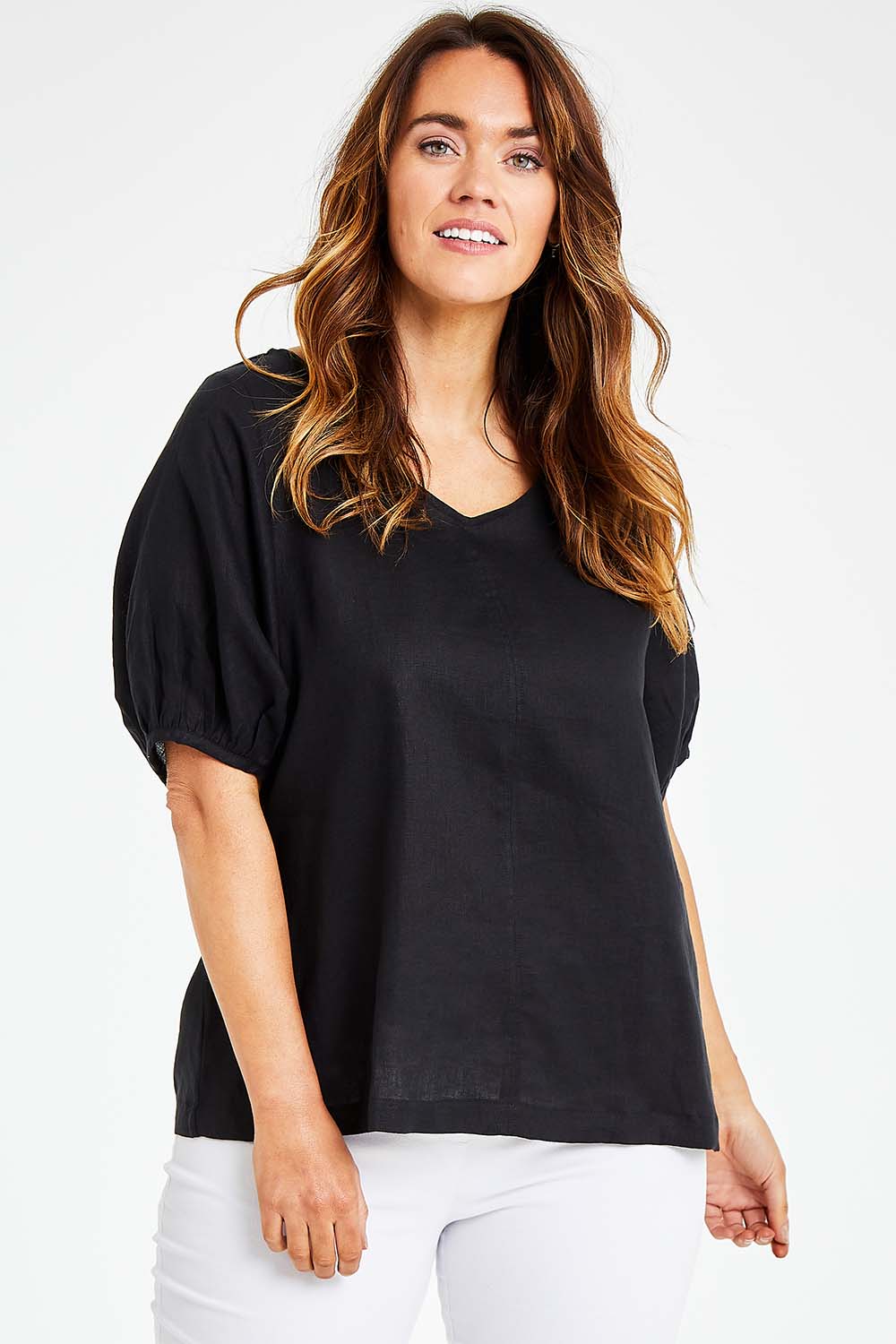 Model Laura wearing size L of the Bishop Sleeve Tee in colour Black (Black), from the front, cropped image