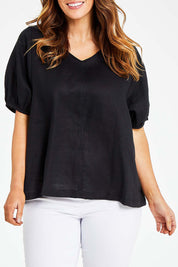 Model Laura wearing size L of the Bishop Sleeve Tee in colour Black (Black), from the front, cropped image