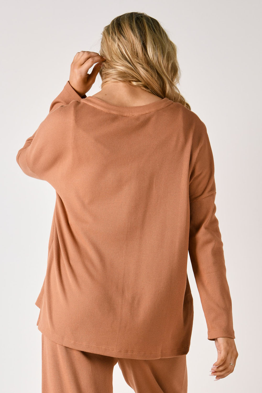 A model wearing the Waffle Jersey 1/2 Placket Top in colour Mocha, from the back