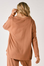A model wearing the Waffle Jersey 1/2 Placket Top in colour Mocha, from the back