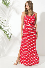 A model wearing the Zuzka Dress in colour Soundgarde (Red), from the front, showing the whole outfit