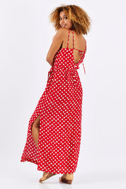 Model Summer wearing size 1 of the Zuzka Dress in colour Soundgarde (Red), from the back