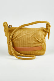 A model wearing the Corduroy Crossbody Bag in colour Mustard, from the front, showing the whole outfit