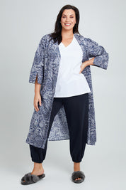Model Poppy wearing the Summer Cotton Robe With Tie in colour Navypais (Blue), from the front, showing the whole outfit