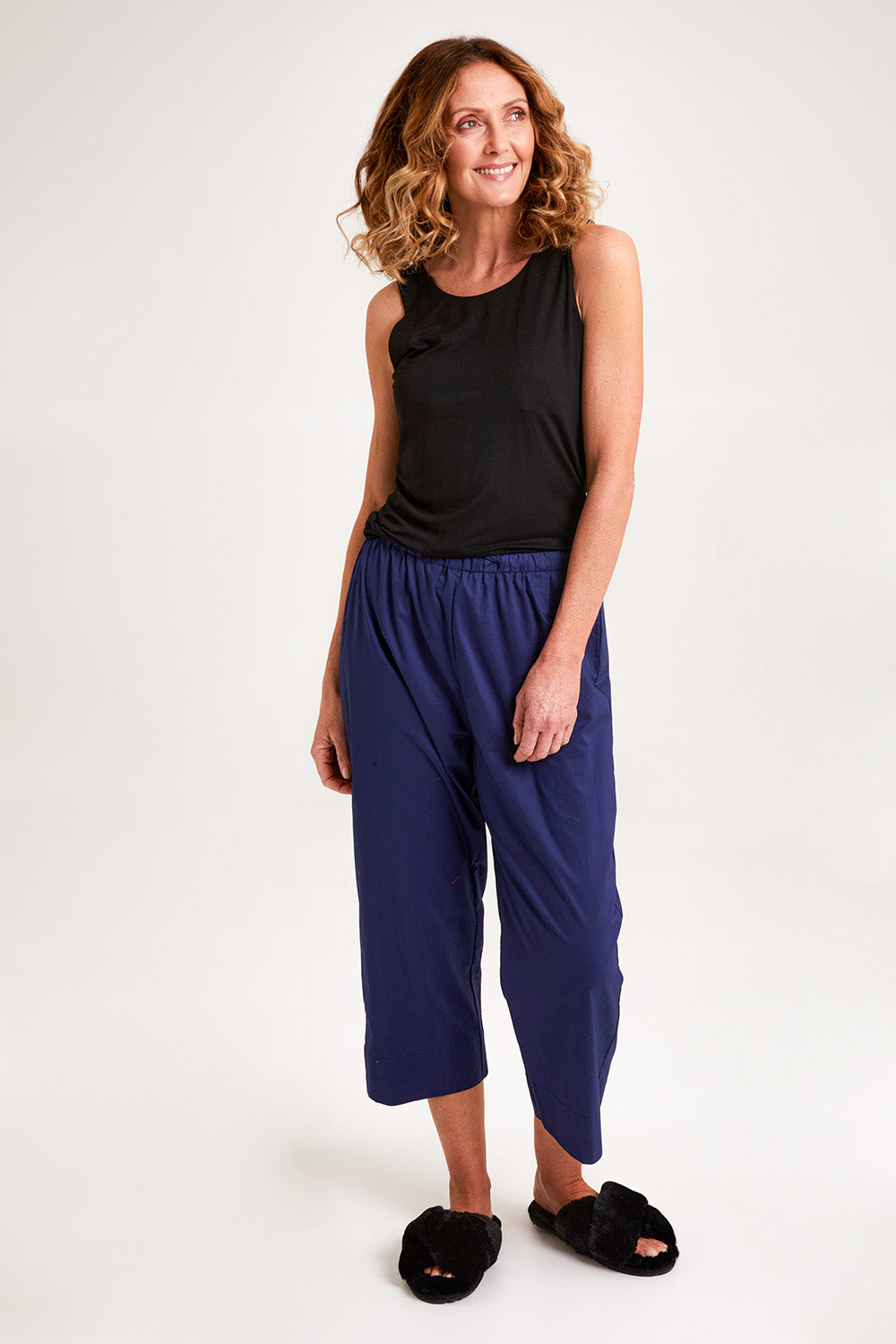 Model Emma wearing the Modal Shelf Bra Tank in colour Black (Black), from the front, showing the whole outfit