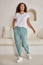 Model Tahneei wearing size 10 of the Cotton Jersey Pull On Jogger – Sage in colour Sage, from the front