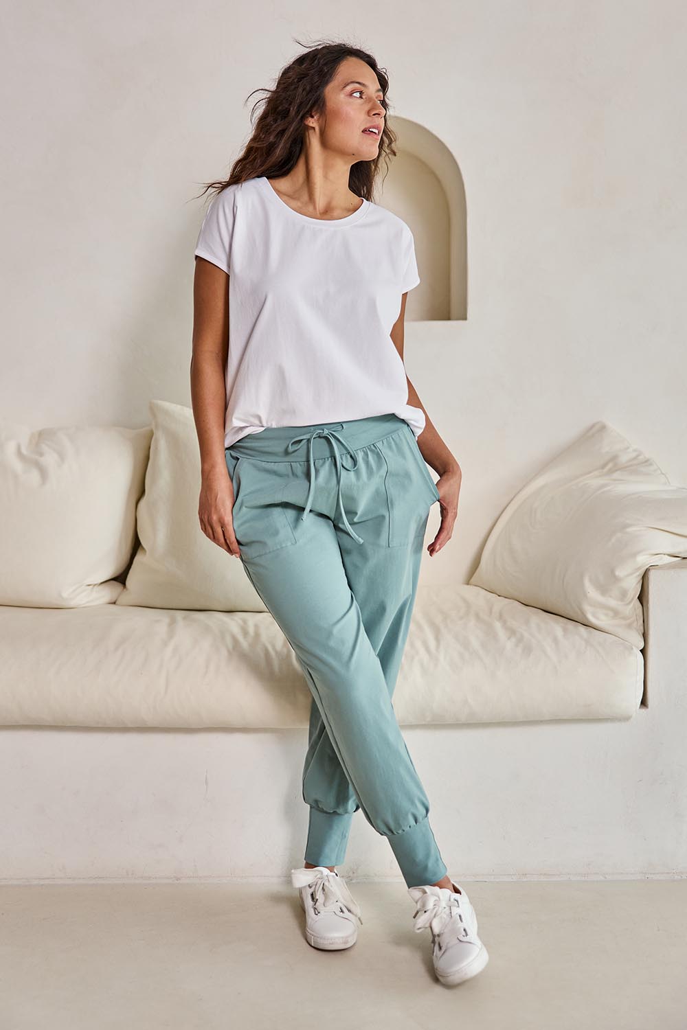 Model Tahneei wearing size 10 of the Cotton Jersey Pull On Jogger – Sage in colour Sage, from the front