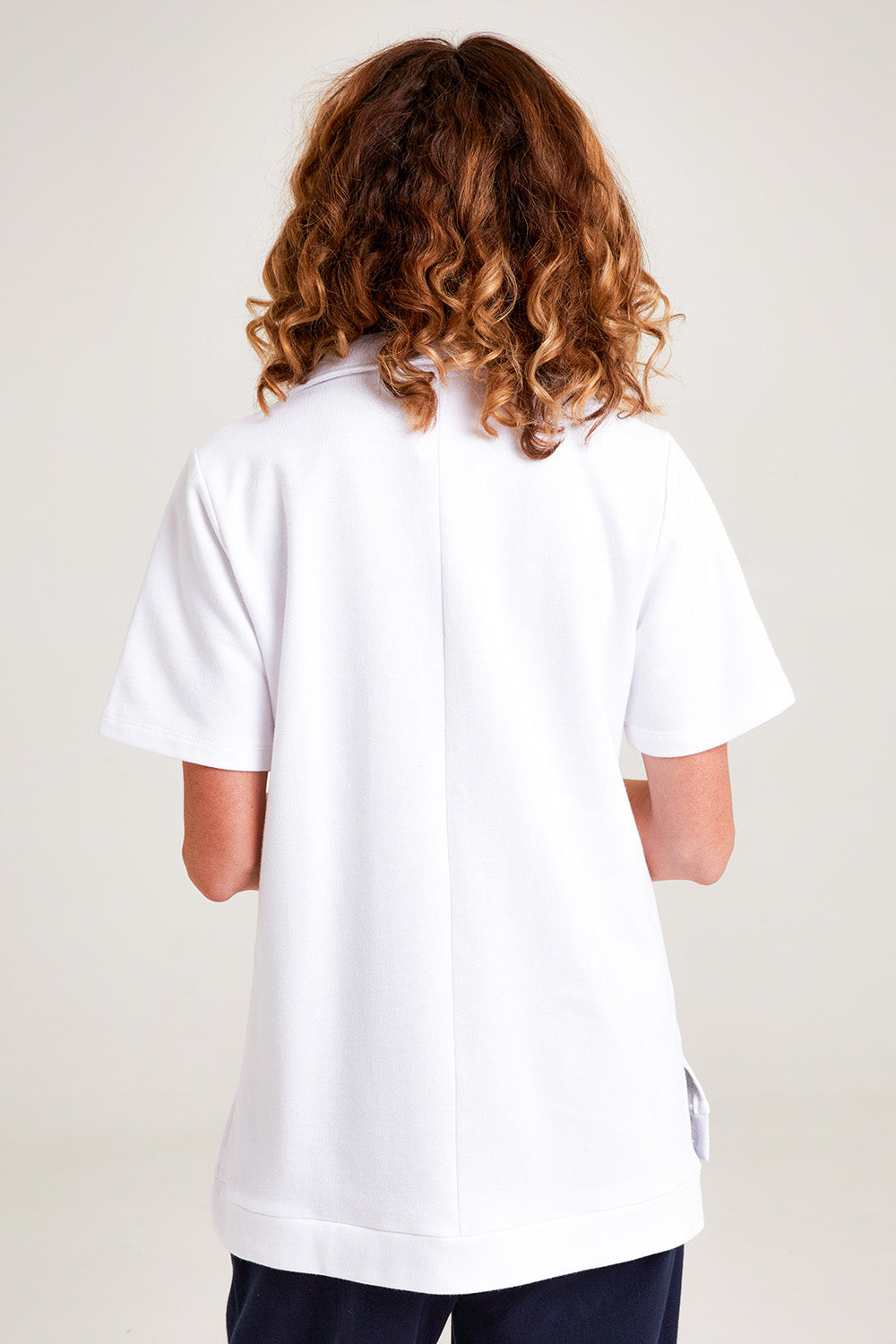 Model Emma wearing the Cotton Terry Collared Tee in colour White (White), from the back
