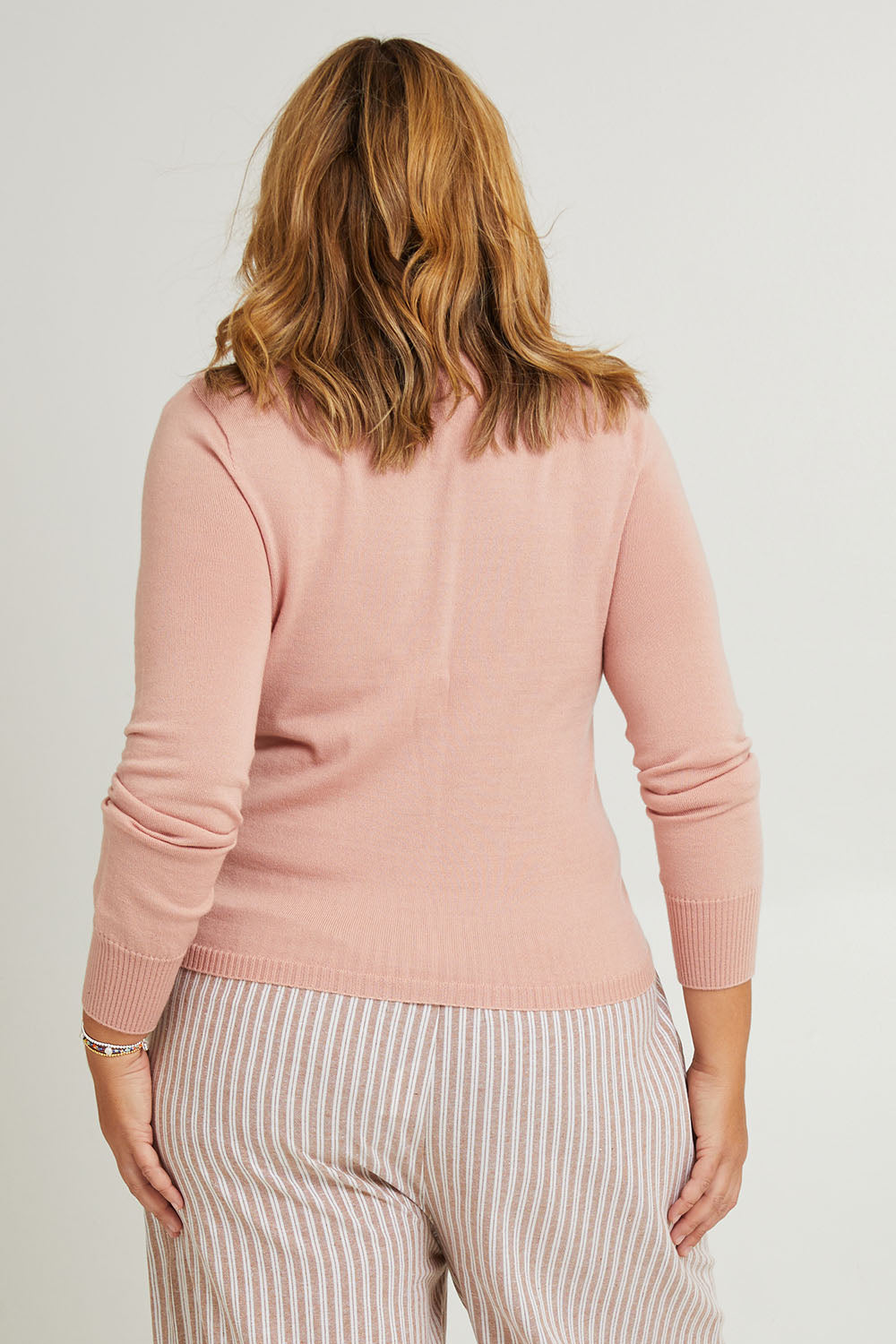 Model Fiona wearing the Wool Saddle Shoulder Sweater in colour Blushpink (Pink), from the back