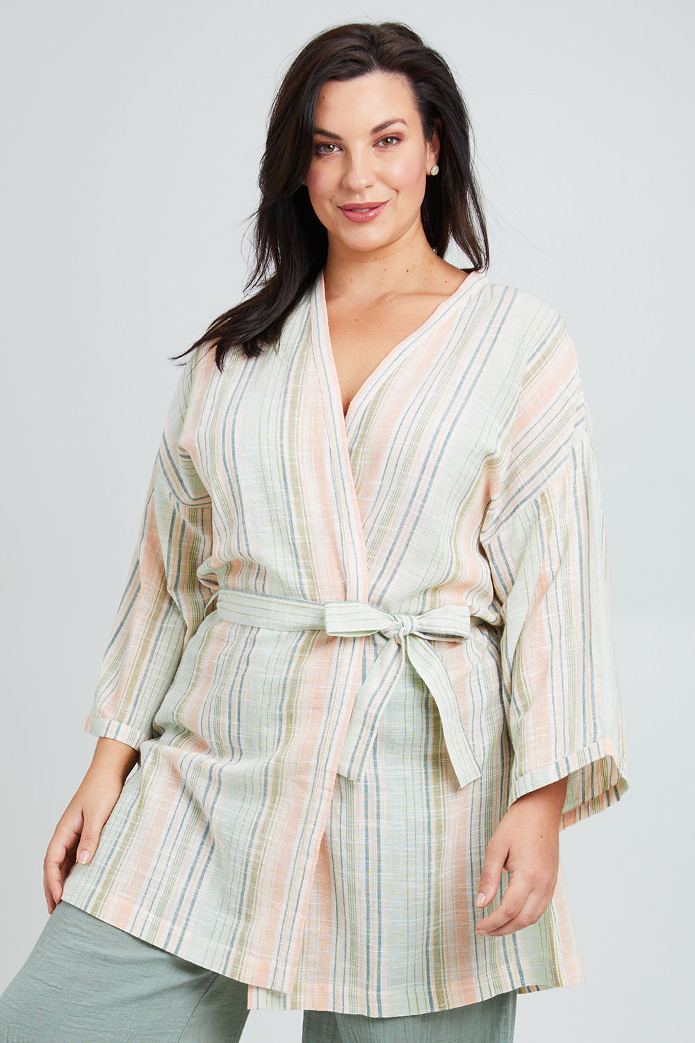 Model Poppy wearing the Cotton Stripe Dressing Robe in colour Softstripe (Green), from the front, cropped image