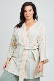 Model Poppy wearing the Cotton Stripe Dressing Robe in colour Softstripe (Green), from the front, cropped image