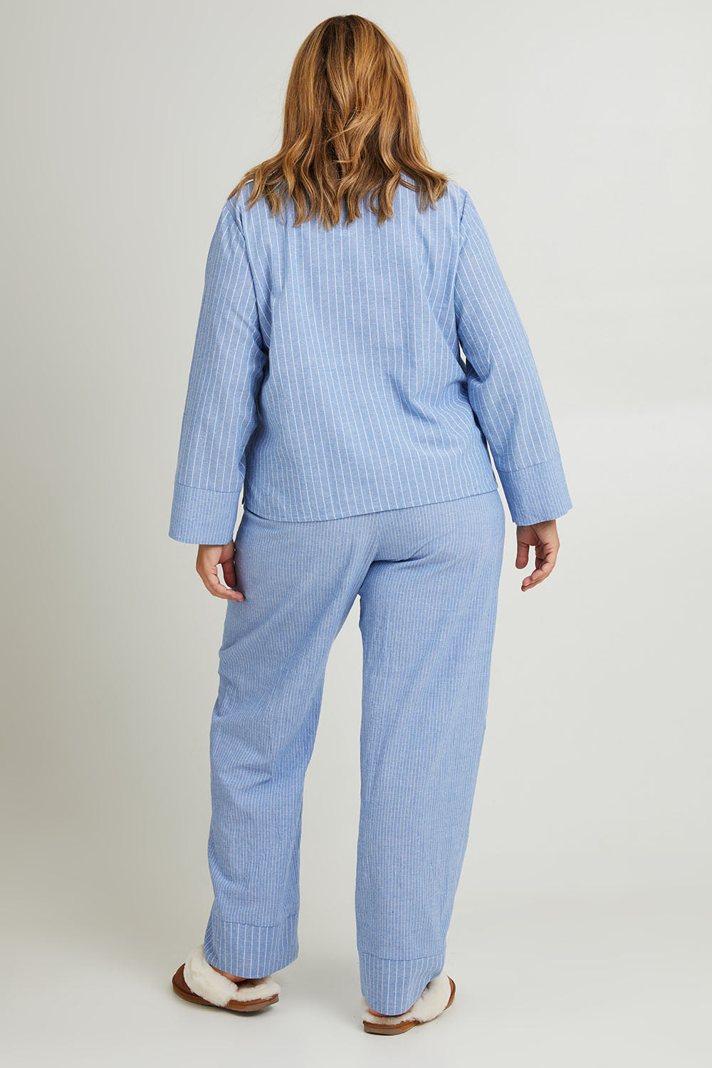 Model Fiona wearing the Cotton Linen Mismatched Pyjama Set in colour Denimstrip (Blue), from the back