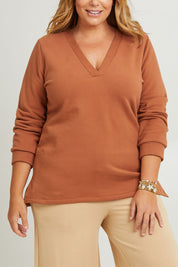 Model Fiona wearing the Cotton Fleece V Neck Sweater in colour Toffee, from the front, cropped image
