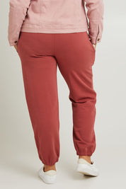 Model Fiona wearing the Cotton Terry Track Pants in colour Pinkclay (Pink), from the back