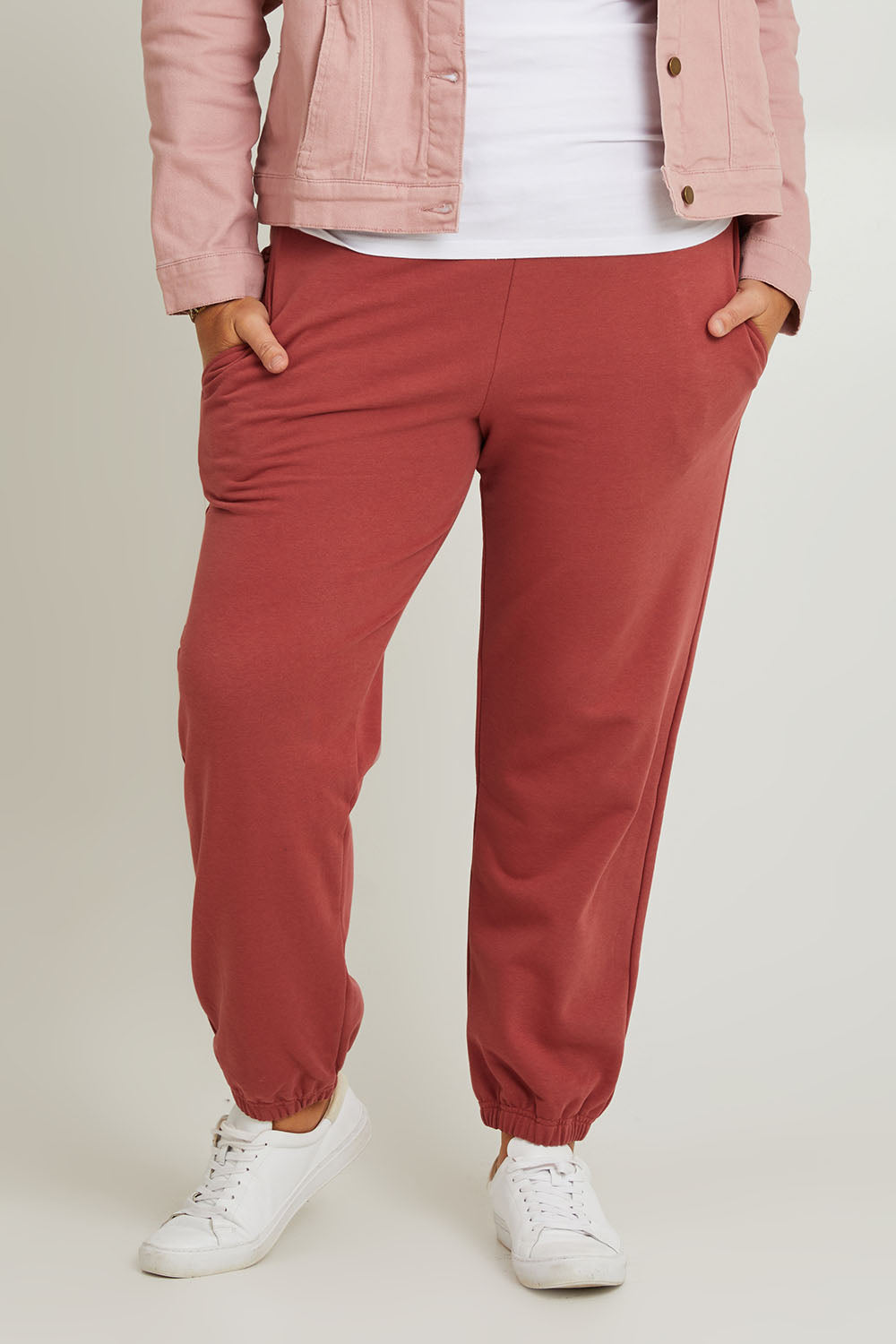 Model Fiona wearing the Cotton Terry Track Pants in colour Pinkclay (Pink), from the front, cropped image