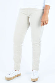 Model Nadine wearing size 10 of the Skinny Leg Cord Pull On Pant in colour Bone, from the front, cropped image