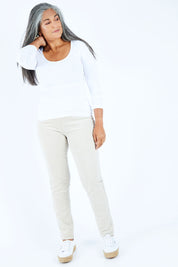 Model Nadine wearing size 10 of the Skinny Leg Cord Pull On Pant in colour Bone, from the front, showing the whole outfit