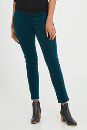 Model Aiyana wearing size 10 of the Skinny Leg Cord Pull On Pant in colour Peacock (Green), from the back